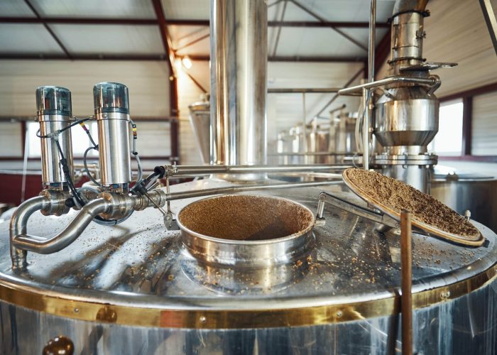 brewing-1 Malted barley is added to a brewing vessel at the Rozelieures distillery, where the brewing stage begins in the production of French single malt whisky.