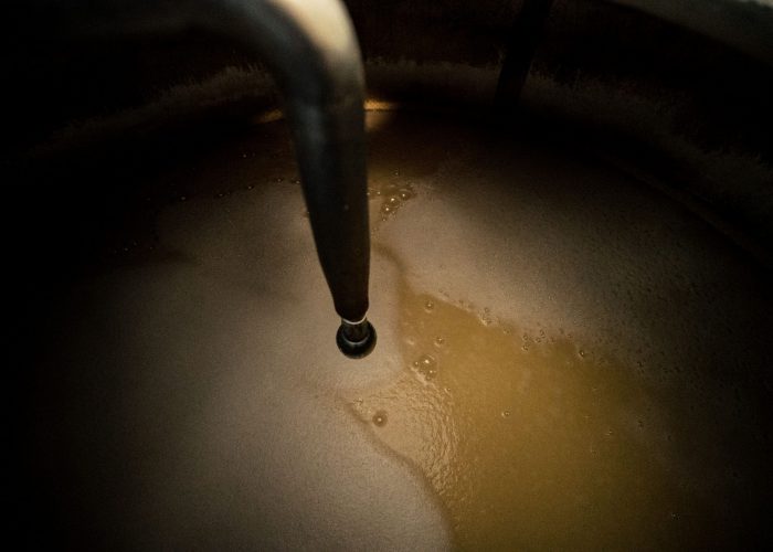 brewing-3 Liquid is stirred inside a brewing vessel at the Rozelieures distillery, where malt and water are mixed during the brewing stage of French single malt whisky production.