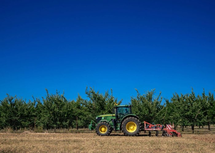moisson-5 A tractor works the fields near Rozelieures in Lorraine, France, reflecting the agricultural landscape surrounding the distillery.