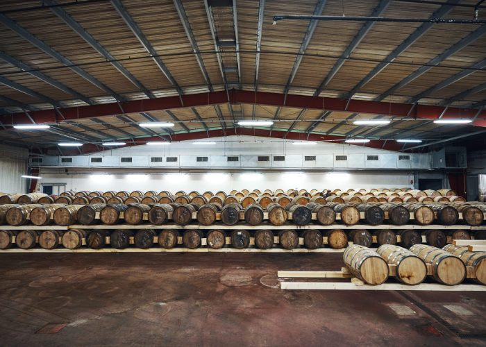 vieillissement-1 Rows of oak casks aging whisky inside the Rozelieures warehouses, where time and controlled conditions shape the character of French single malt whisky.